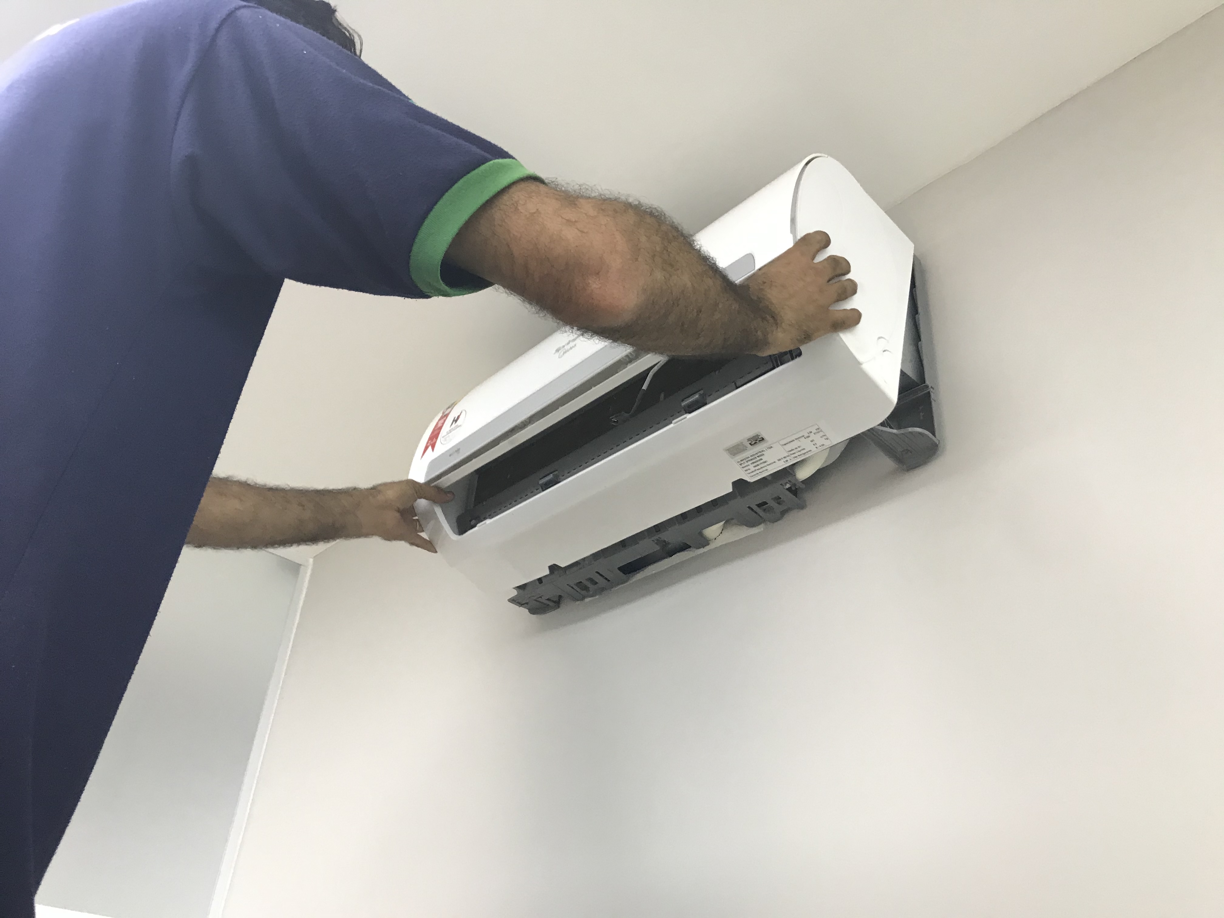 Técnico FAS Brasil realizando manutenção preventiva de ar-condicionado em ambiente corporativo